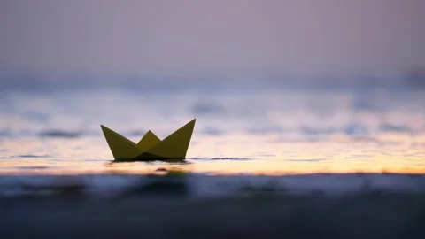 Paper boat touch ground at shallow place but then sail again, driven by wind Video stock 162827545