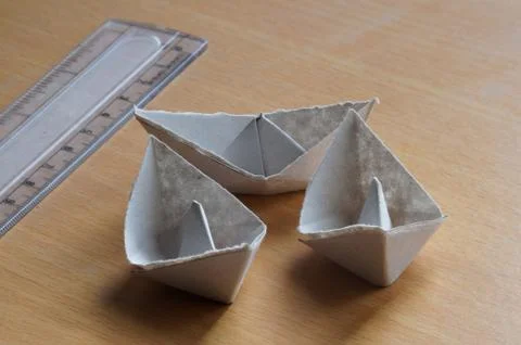 Paper boats on the table Stock Photos