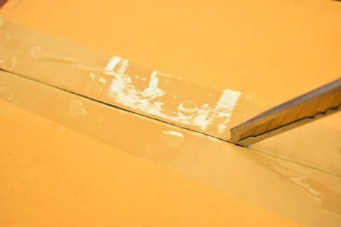 Paper box with sharp knife, packaging industry Stock Photos