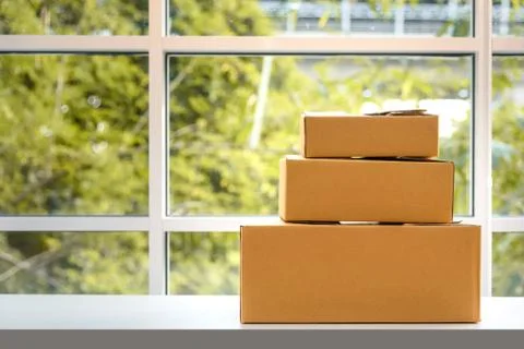 Paper boxes on table, natural background, online shopping concept Stock Photos