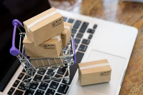 Paper boxes in a trolley on a laptop computer ,Easy shopping online concept.. Stock Photos