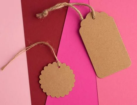 Paper brown round and rectangular price tag on a rope 写真素材