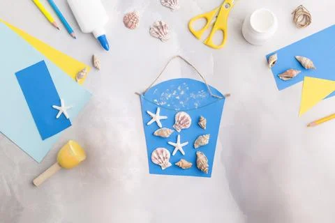 Paper bucket of shells summer idea for kids craft in kindergarten ocean's day Stock Photos