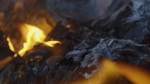 The paper burns with a bright flame in the fire. The paper turns into ashes. Stock Footage 122346314