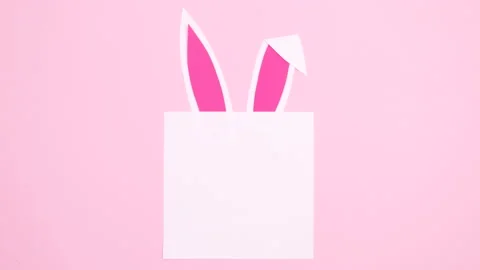Paper card note for Easter with moving bunny ears . Minimal flat lay stop motion Stock Footage 149917370
