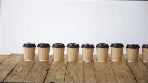 Paper caup from cardboard above rustic wooden table action Stock Footage 64490285