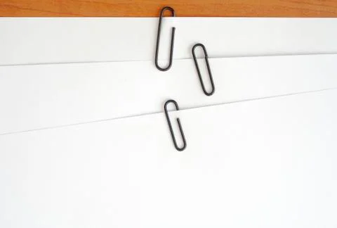 Paper clips attached to multiple sheets of paper Stock Photos