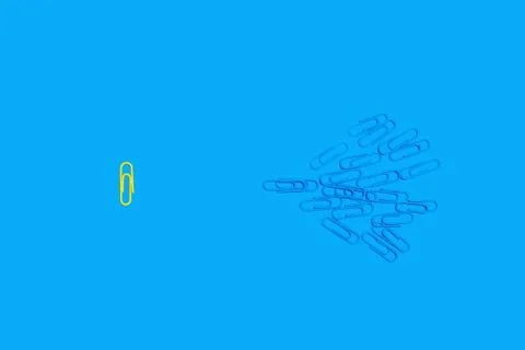 Paper clips on a blue background Stock Photos