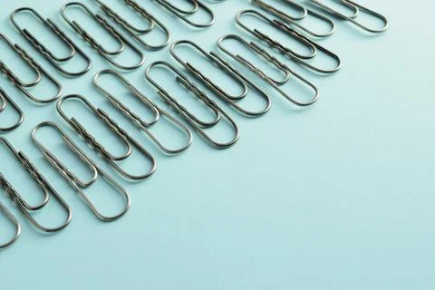 Paper clips on a blue background Stock Photos