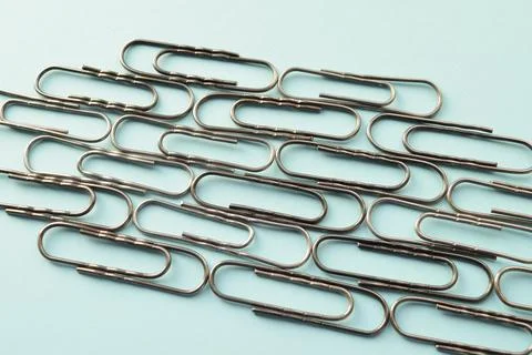 Paper clips on a blue background Stock Photos