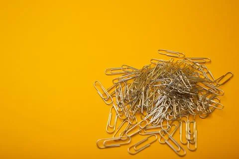 Paper clips on a bright background Stock Photos