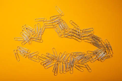 Paper clips on a bright background Stock Photos