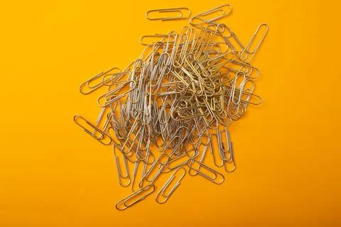 Paper clips on a bright background Stock Photos