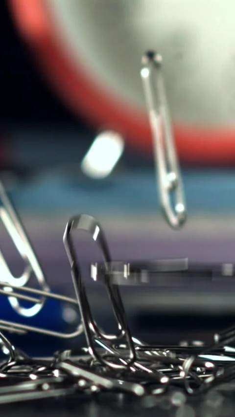 Paper clips fall on the table. Filmed on a high-speed camera at 1000 fps Stock Footage 335381584