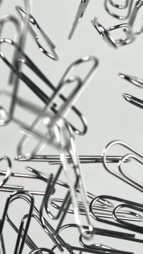 Paper clips fly and fall. Filmed on a high-speed camera at 1000 fps Stock Footage 335377236