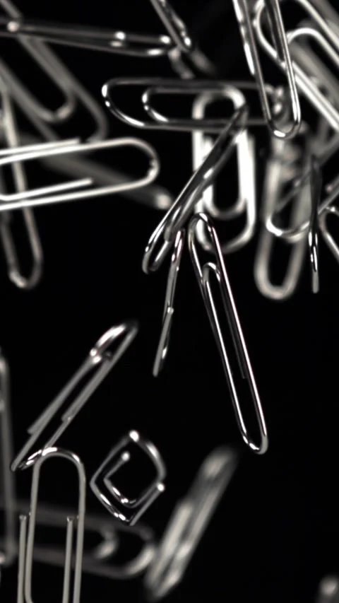Paper clips fly and fall. Filmed on a high-speed camera at 1000 fps Stock Footage 335377604
