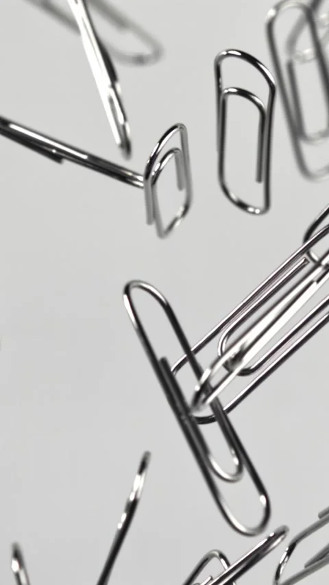 Paper clips fly and fall. Filmed on a high-speed camera at 1000 fps Stock Footage 335380679