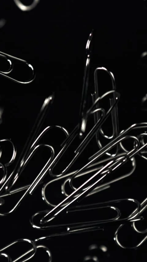 Paper clips fly and fall. Filmed on a high-speed camera at 1000 fps Stock Footage 335381499