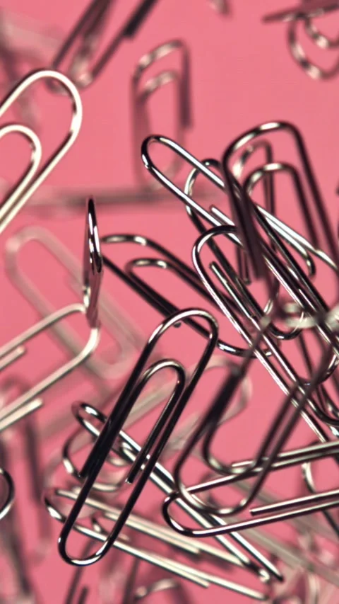 Paper clips fly and fall. Filmed on a high-speed camera at 1000 fps Stock Footage 335381526