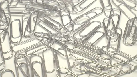 Paper clips rotate on white background Stock Footage 153391984