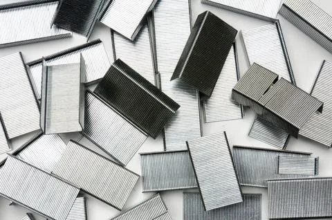 Paper clips from a stapler on a white background Stock Photos