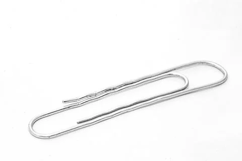 Paper clips on white background with text space Foto stock