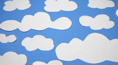 Paper clouds on blue background. Cloud computing concept. Stock Photos