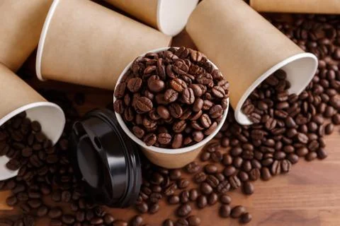 Paper coffee cup with beans Stock Photos