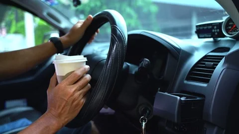 Paper coffee cup in man's hand the car is parked on the road Video stock 213865475