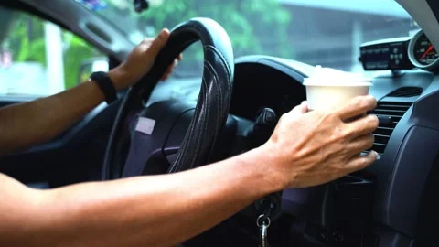 Paper coffee cup in man's hand the car is parked on the road Video stock 213867204