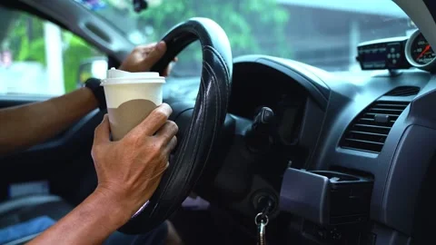 Paper coffee cup in man's hand the car is parked on the road Video stock 213868374