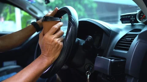 Paper coffee cup in man's hand the car is parked on the road Video stock 213868393