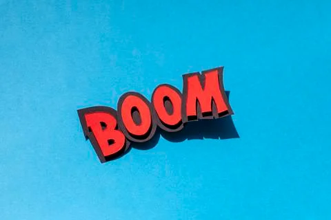 Paper comic speech bubble on blue background. Boom. Stock Photos