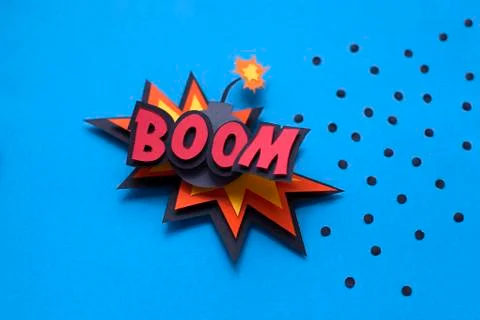 Paper comic speech bubble on blue background. Boom. Bomb. Stock Photos