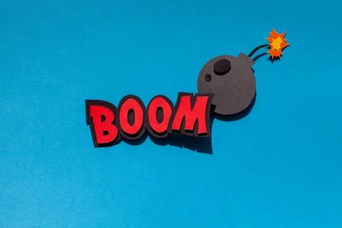 Paper comic speech bubble on blue background. Boom. Bomb. Stock Photos