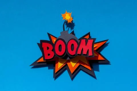 Paper comic speech bubble on blue background. Boom. Bomb. Stock Photos