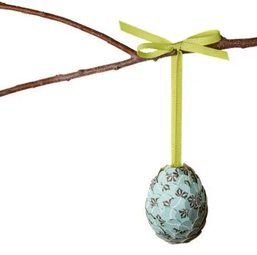 Paper covered easter egg hanging from a branch Stock Photos