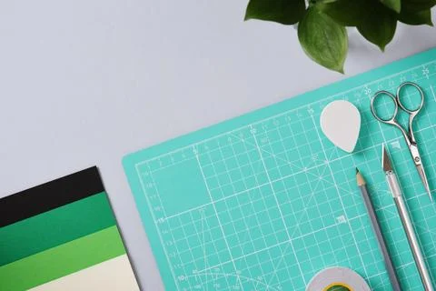 Paper crafting work table: scissors, craft knife, pencil, tweezers, eraser, p Stock Photos