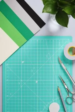 Paper crafting work table: scissors, craft knife, pencil, tweezers, eraser,.. Stock Photos