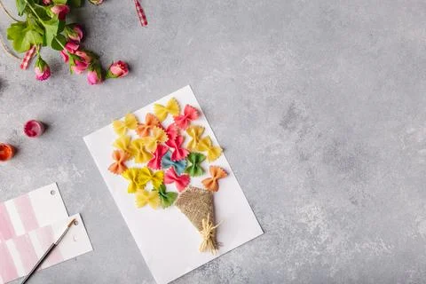 Paper crafts for mother day, 8 march or birthday. Small child doing a bouquet of Stock Photos