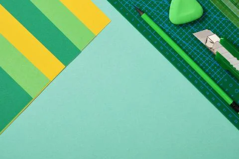Paper crafts work table top view. Hobby tools, green cutting mat, stationer.. Stock Photos