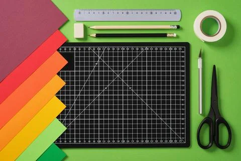 Paper crafts work table top view. Tools for creativity. Black cutting mat, .. Stock Photos