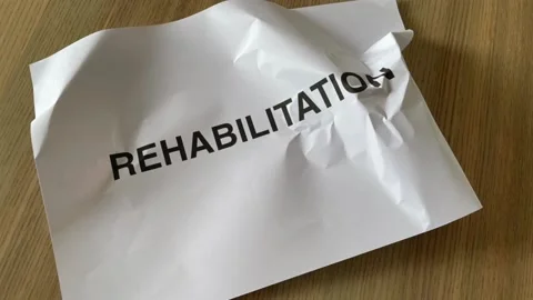 Paper crumpled into ball in stop motion with "REHABILITATION" word Stock Footage 172289216