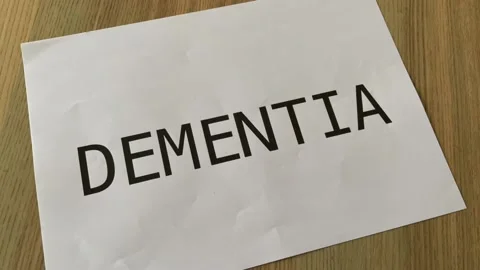 Paper crumpled into ball in stop motion printed black text "DEMENTIA" Stock Footage 172289294