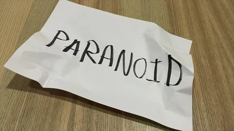 Paper crumpled into ball in stop motion printed black text “PARANOID” Stock Footage 172355502