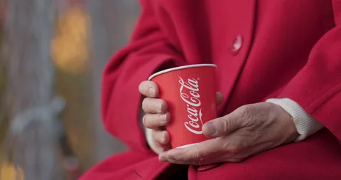 Paper cup with Coca-Cola logo in hands of an elderly man Stock Footage 140816956