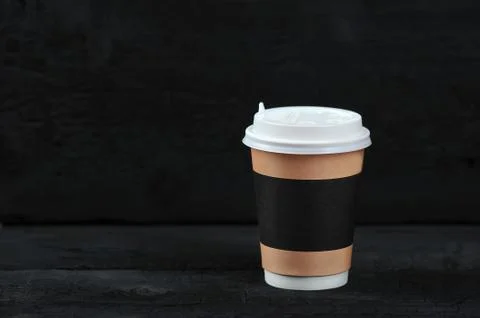 Paper Cup with coffee on black rustic background Stock Photos