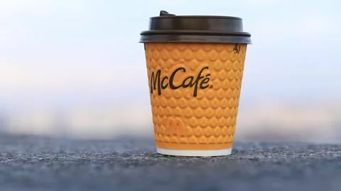 Paper cup with coffee for McCafe drinks. Takeaway drink Stock Footage 266255743