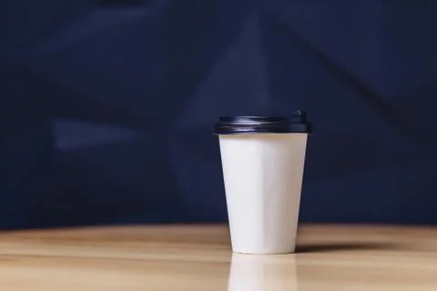 Paper cup of coffee on table Stock Photos
