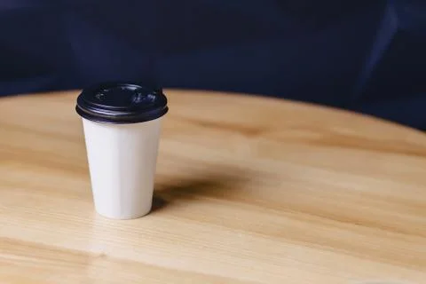 Paper cup of coffee on table Stock Photos
